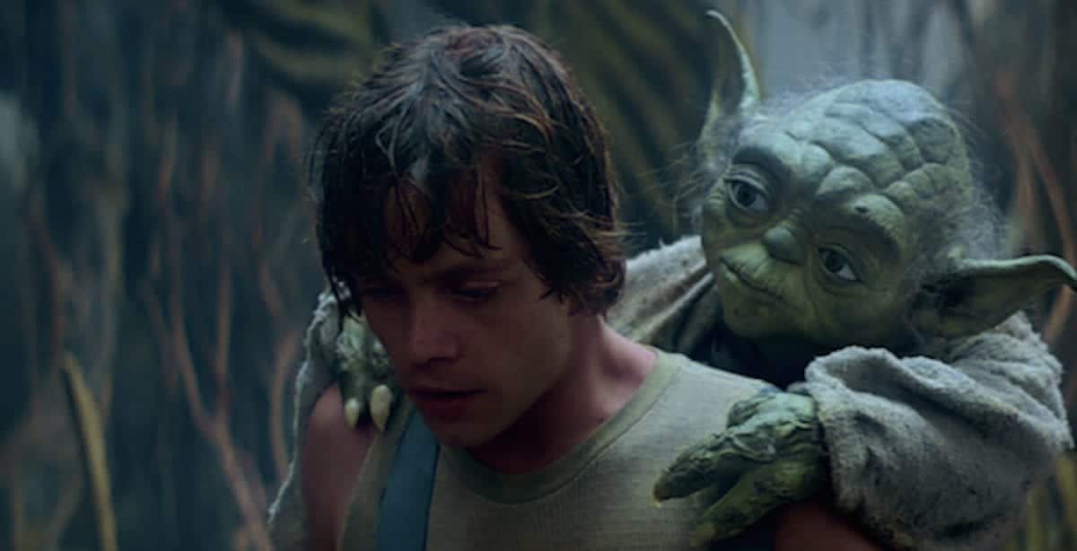 Yoda riding Luke Skywalker's back through the swamp